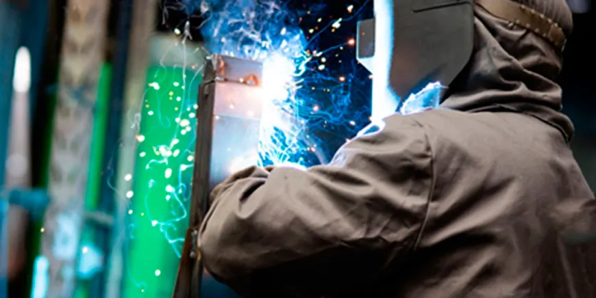 Welder performing industrial metal fabrication
